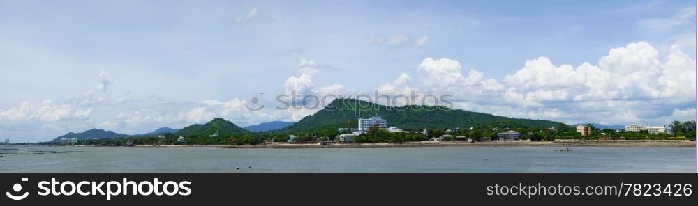 panorama coast and mountain.Sky with clouds. Clear the air. Buildings along the coast.