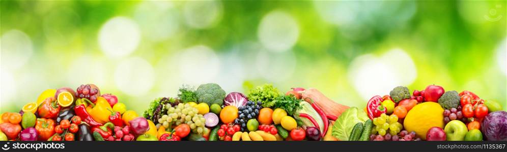 Panorama fresh fruits and vegetables on green background. Collage for skinali (glass panel)