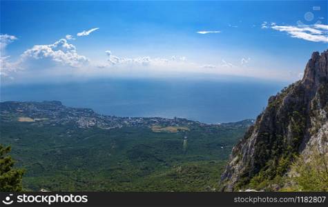 Panorama from Mount Ai-Petri overlooking the city of Miskhor and the Black Sea on a sunny day, Crimea.