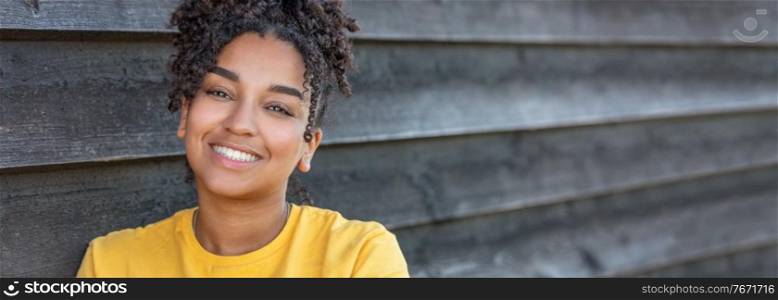 Panorama girl teenager teen female young African American mixed race biracial woman outside smiling with perfect teeth panoramic header web banner