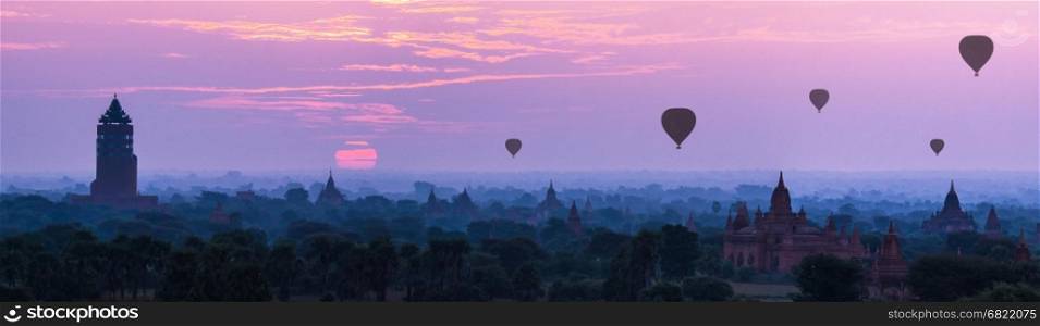 Panorama Hot air ballons over pagodas in sunrise at Bagan, Myanmar.