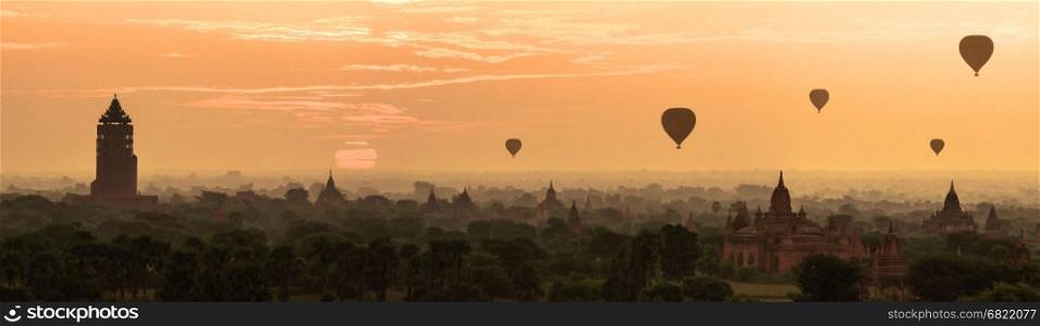 Panorama Hot air ballons over pagodas in sunrise at Bagan, Myanmar.