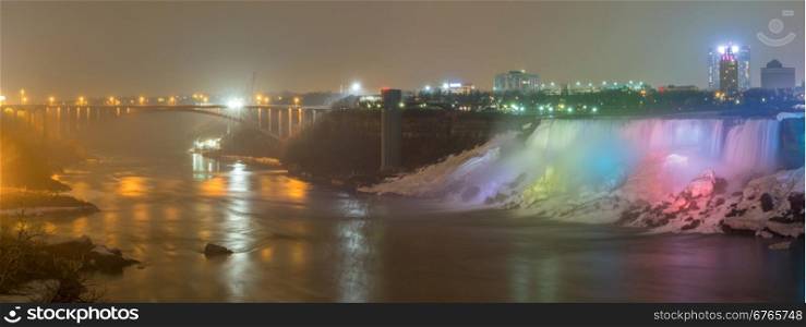 Panorama Illumination light of american Falls as viewed from Table Rock in Queen Victoria Park in Niagara Falls at night, Ontario, Canada