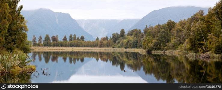 Panorama Landscape Mount cook at Lake Matheson with cloudy sky New Zealand