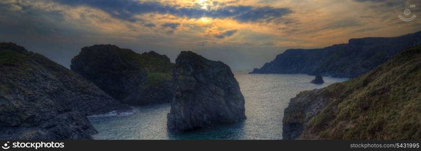 Panorama landscape of rocky coastline at sunset