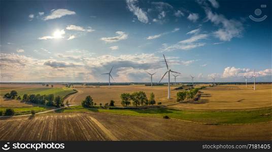 Panorama of a rural region with windmills in sunshine