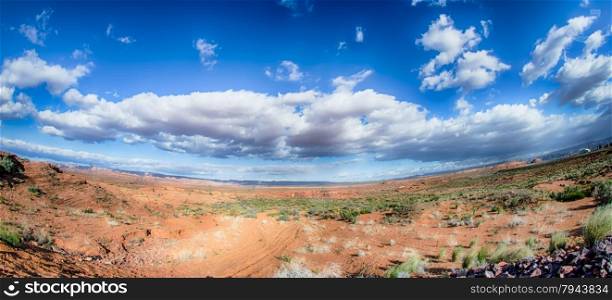 panorama of a valley in utah desert with blue sky