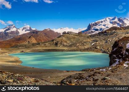 Panorama of Alps mountain landscape and mountain lake in a beautiful day in Switzerland