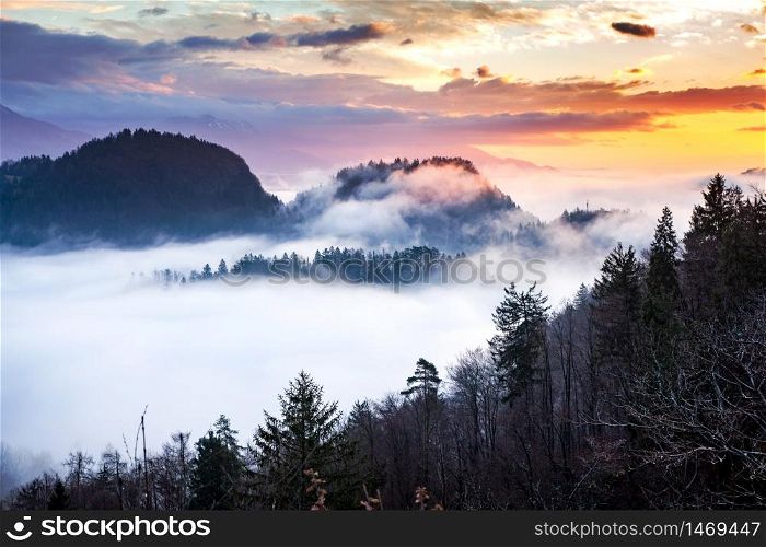 panorama of amazing foggy sunrise over mountains