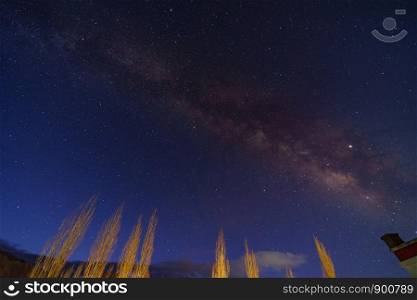 Panorama of arching Milky Way galactic center over the mountain at Leh city, Ladakh, Jammu and Kashmir, India.