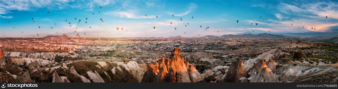 Panorama of Cappadocia with balloons at sunset. Goreme, Turkey. Logos and trademarks removed.. Panorama of Cappadocia with balloons at sunset