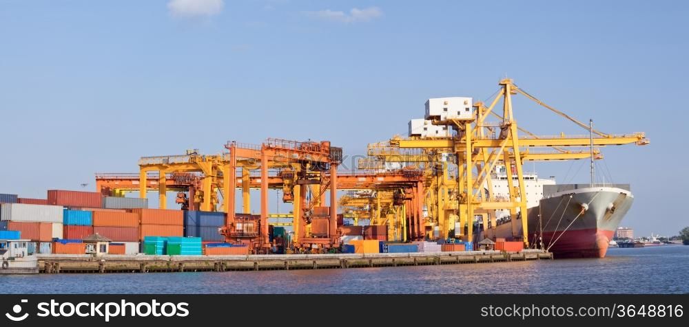 Panorama of Cargo industrial ship unloading goods at Terminal Port