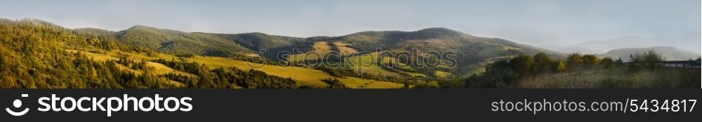 Panorama of Carpathian mountains. Fields and forests near the road.