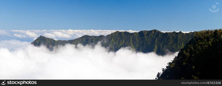 Panorama of clouds forming on Kalalau valley in Kauai Na Pali Coast