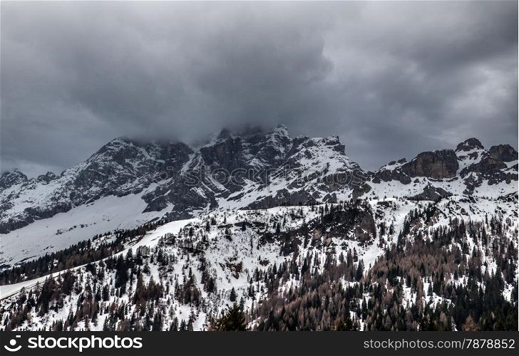 Panorama of cloudy spring weather in Dolomites mountains. Italian Dolomites