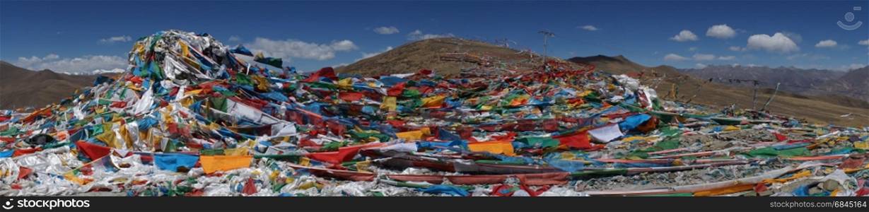 Panorama of color flags on the mountain pass in Tibet. Color flags