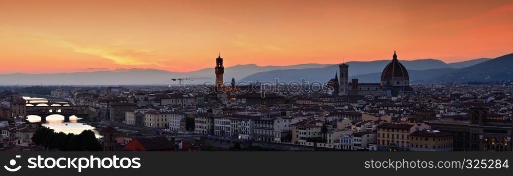 Panorama of Duomo Santa Maria Del Fiore, tower of Palazzo Vecchio and famous bridge Ponte Vecchio at sunset in Florence, Tuscany, Italy
