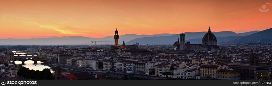 Panorama of Duomo Santa Maria Del Fiore, tower of Palazzo Vecchio and famous bridge Ponte Vecchio at sunset in Florence, Tuscany, Italy