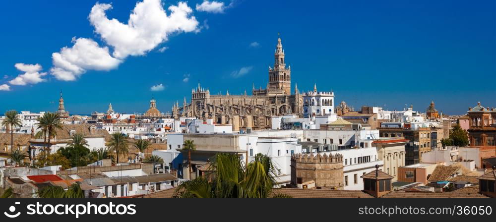 Panorama of Famous Bell Tower named Giralda in landmark catholic Cathedral Saint Mary of the See, aerial view from the Torre Del Oro, Seville, Andalusia, Spain