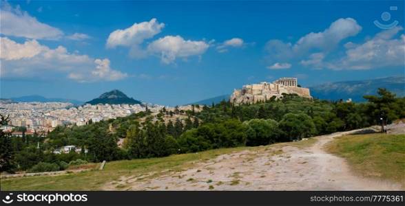 Panorama of famous greek tourist landmark - the iconic Parthenon Temple at the Acropolis of Athens as seen from Philopappos Hill, Athens, Greece. Iconic Parthenon Temple at the Acropolis of Athens, Greece