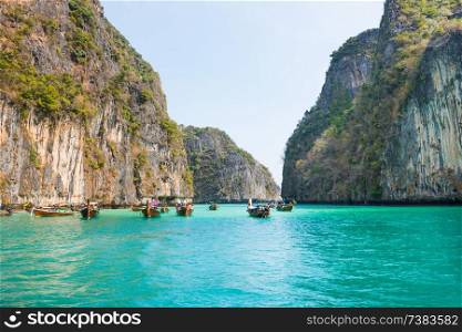 Panorama of famous Phi Phi island in Thailand with sea, boats and mountains in beautiful lagoon where the Beach movie was filmed