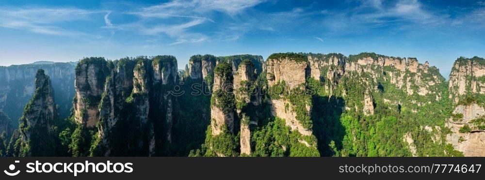 Panorama of famous tourist attraction of China Avatar mountains - Zhangjiajie stone pillars cliff mountains on sunset at Wulingyuan, Hunan, China. Zhangjiajie mountains, China