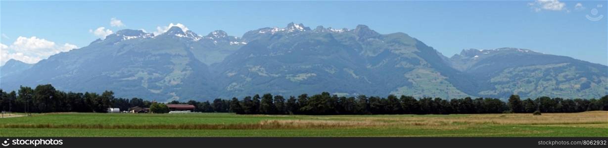 Panorama of farm field and mountain range in Lichtenstein