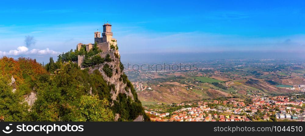 Panorama of First tower Guaita fortress in the city of San Marino of the Republic of San Marino and italian hills in sunny day. Guaita fortress in San Marino