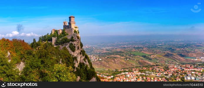 Panorama of First tower Guaita fortress in the city of San Marino of the Republic of San Marino and italian hills in sunny day. Guaita fortress in San Marino