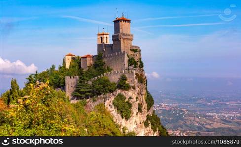 Panorama of First tower Guaita fortress in the city of San Marino of the Republic of San Marino and italian hills in sunny day. Guaita fortress in San Marino