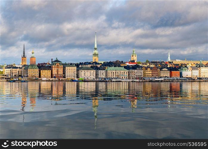 Panorama of Gamla Stan in Stockholm, Sweden. The town dates back to 13th Century. The brightly colored city reflected in artificial water. Panorama of Gamla Stan in Stockholm, Sweden