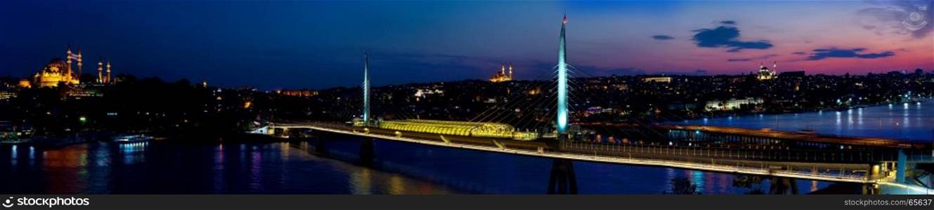 Panorama of Golden Horn in Istanbul with the view of metro bridge at sunset, Turkey