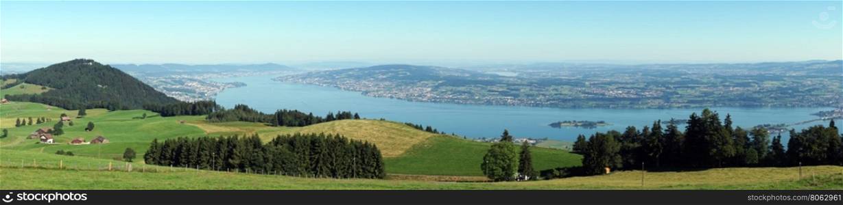 Panorama of green pasture and lake Zurich