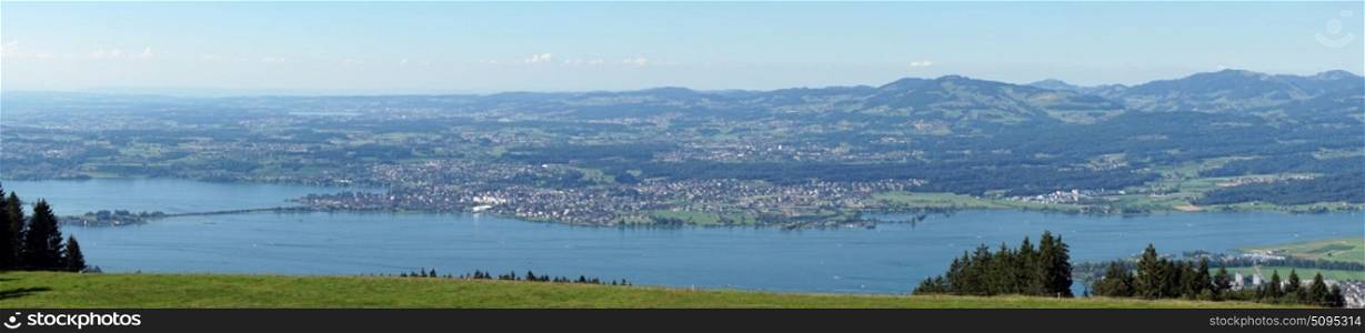 Panorama of green pasture near the lake Zurich in Switzerland