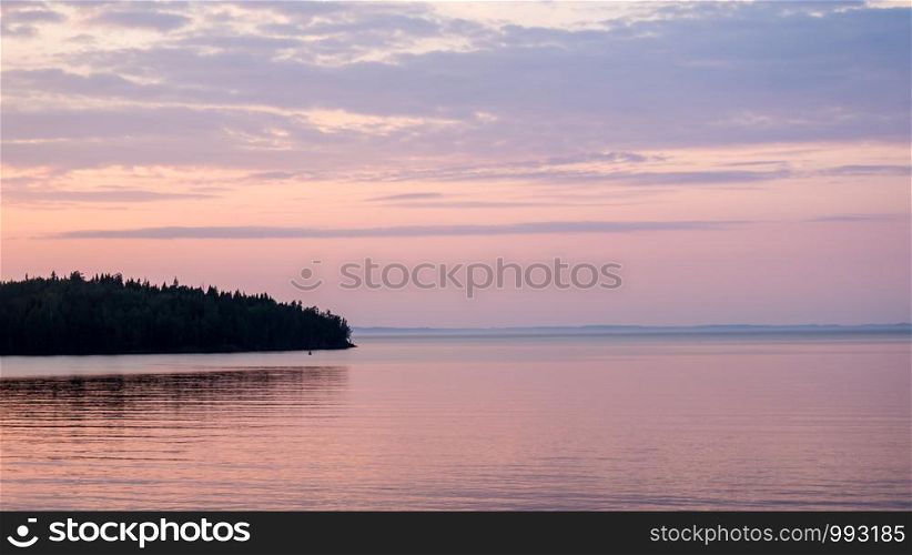 Panorama of Ladoga lake and islands. Sunset hour. Sunset landscape on Lake Ladoga.