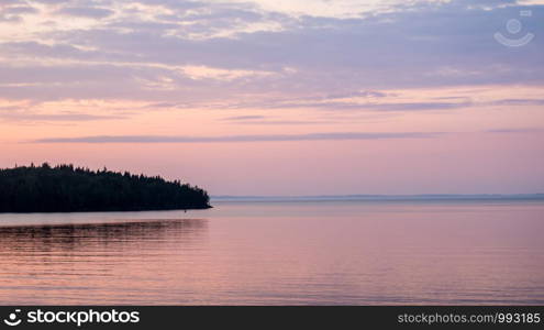 Panorama of Ladoga lake and islands. Sunset hour. Sunset landscape on Lake Ladoga.