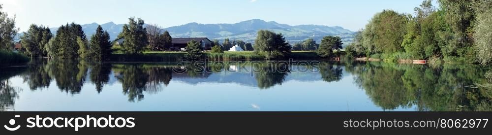 Panorama of lake and trees in Switzerland