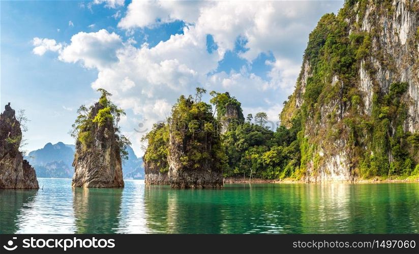 Panorama of Limenstone rocks at Cheow Lan lake, Ratchaprapha Dam, Khao Sok National Park in Thailand in a summer day