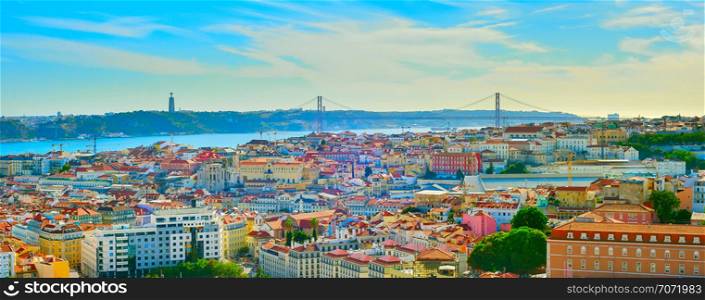 Panorama of Lisbon old town, 25th April Bridge and Christ the King statue on the Tagus river