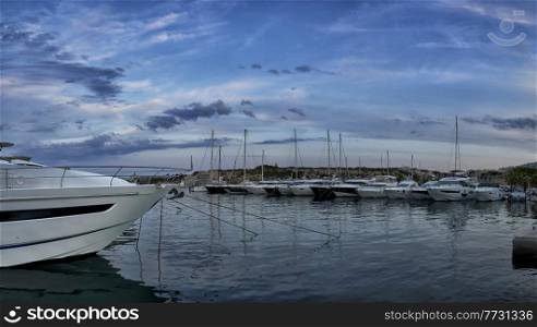 Panorama of luxury boats moored in harbour at dusk