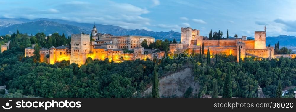 Panorama of Moorish palace and fortress complex Alhambra with Comares Tower, Alcazaba, Palacios Nazaries and Palace of Charles V during evening blue hour in Granada, Andalusia, Spain
