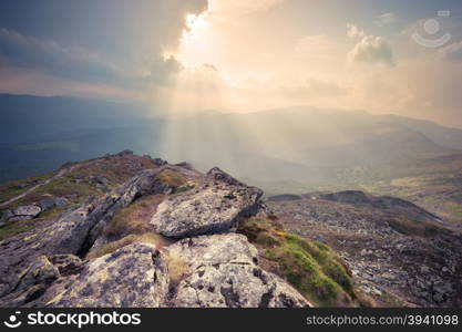 Panorama of mountain hills at cloudy sunset