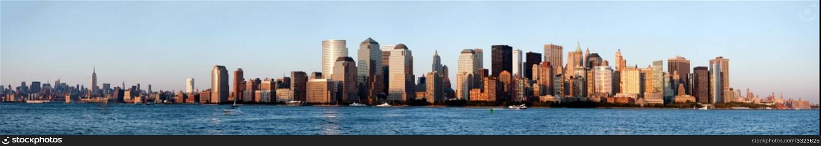 Panorama of New York City Manhattan skyline showing downtown financial district with world trade center WTC and midtown with Empire State building.