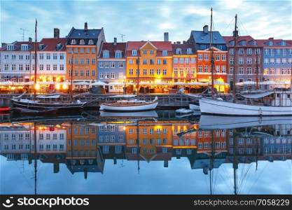 Panorama of north side of Nyhavn with colorful facades of old houses and old ships in the Old Town of Copenhagen, capital of Denmark.. Panorama of Nyhavn in Copenhagen, Denmark.