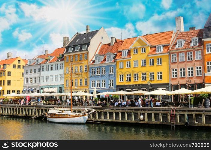 Panorama of north side of Nyhavn with colorful facades of old houses and old ships in the Old Town of Copenhagen