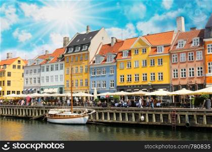 Panorama of north side of Nyhavn with colorful facades of old houses and old ships in the Old Town of Copenhagen