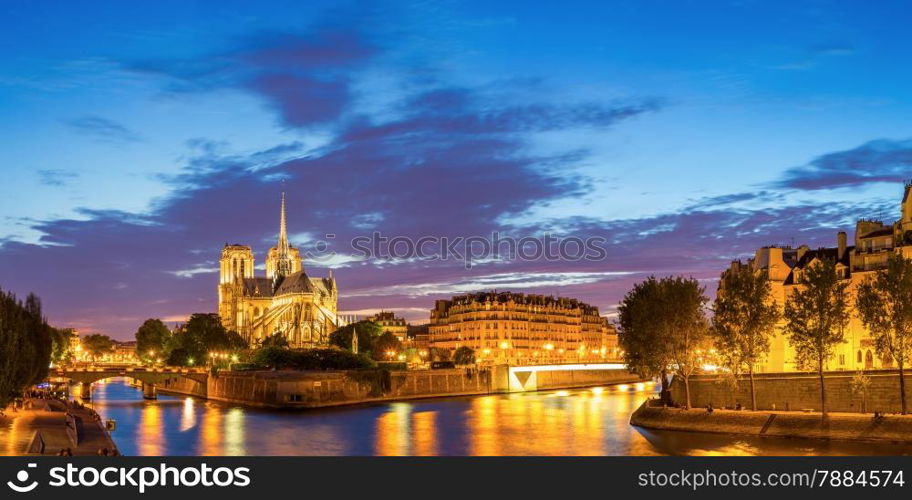 Panorama of Notre Dame Cathedral with Paris cityscape at dusk, France