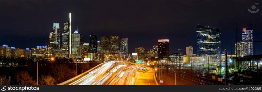 Panorama of Philadelphia skyscraper Skylines building at night illuminated with highway urban road transportation in Philly city downtown of Philadelphia in PA USA. Cityscape Urban lifstyle concept.