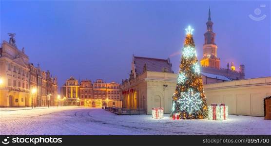 Panorama of Poznan Town Hall and Christmas tree at Old Market Square in Old Town in the snowy night, Poznan, Poland. Night Old Town of Poznan, Poland