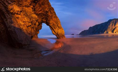 Panorama of rocky arch at the Adraga beach, Portugal